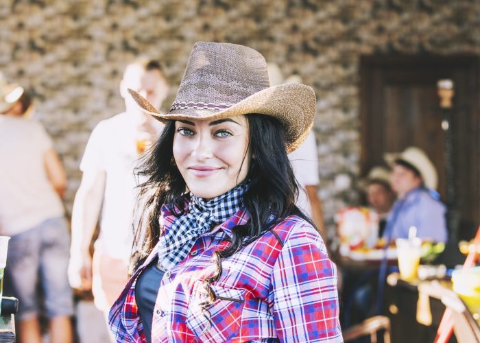 Young woman beautiful cheerful portrait at a party in cowboy style